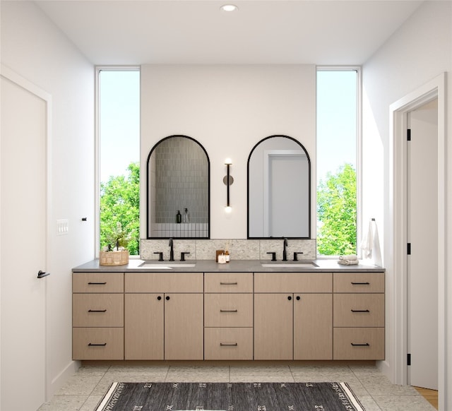 bathroom featuring vanity and backsplash