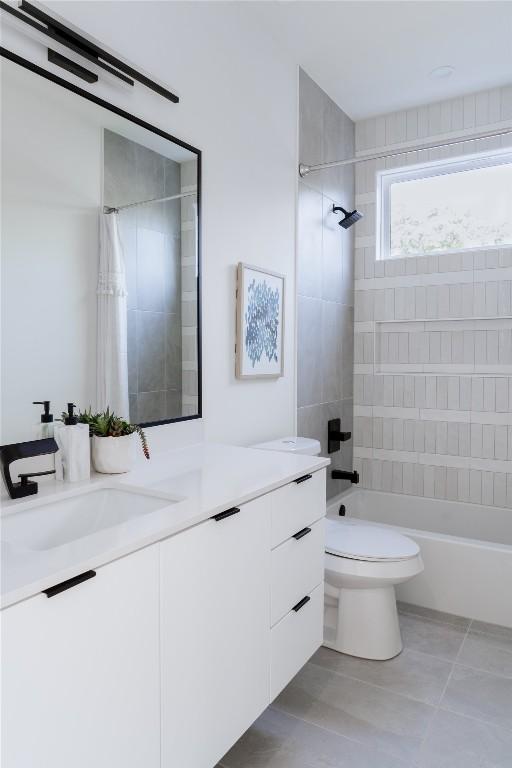 full bathroom featuring tile patterned floors, vanity, toilet, and shower / bath combo