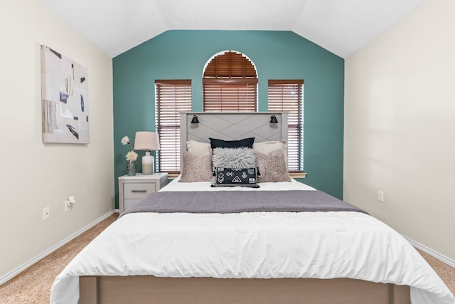 bedroom featuring carpet, multiple windows, and vaulted ceiling