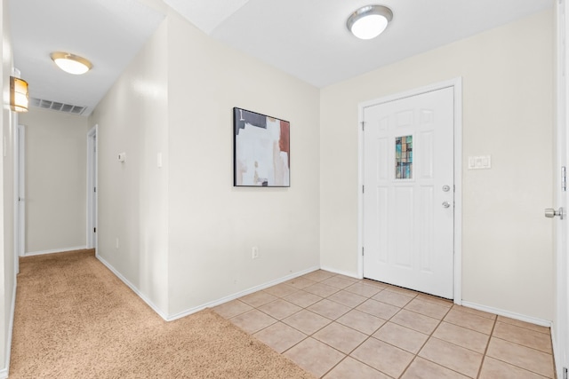 foyer entrance featuring light colored carpet