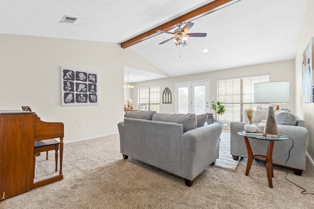 carpeted living room featuring vaulted ceiling with beams and ceiling fan with notable chandelier