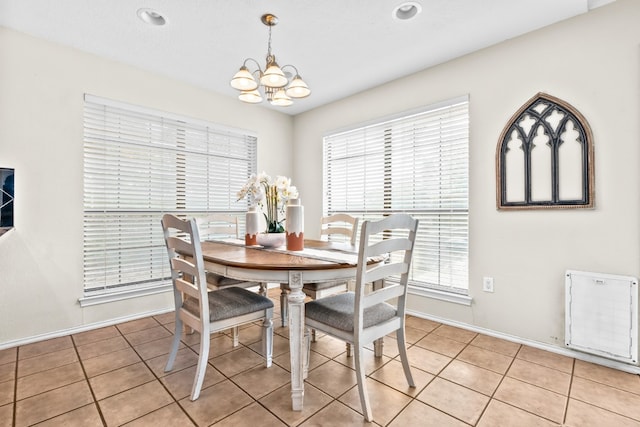 tiled dining space with a notable chandelier