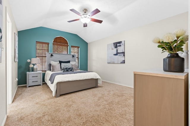 carpeted bedroom with ceiling fan and vaulted ceiling