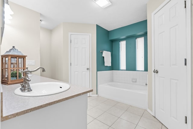 bathroom with tile patterned flooring, vanity, and a tub to relax in