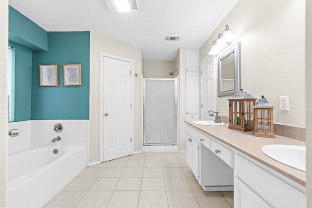 bathroom with independent shower and bath, vanity, and tile patterned floors