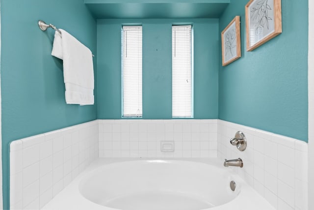 bathroom with a tub to relax in