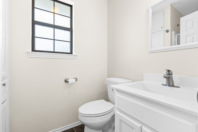 bathroom featuring toilet and vanity