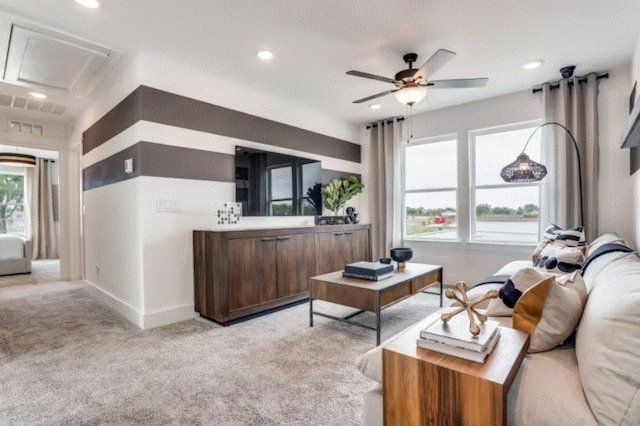 carpeted living room with ceiling fan and a textured ceiling