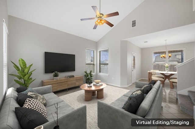 living room with ceiling fan with notable chandelier, a healthy amount of sunlight, light tile patterned floors, and high vaulted ceiling