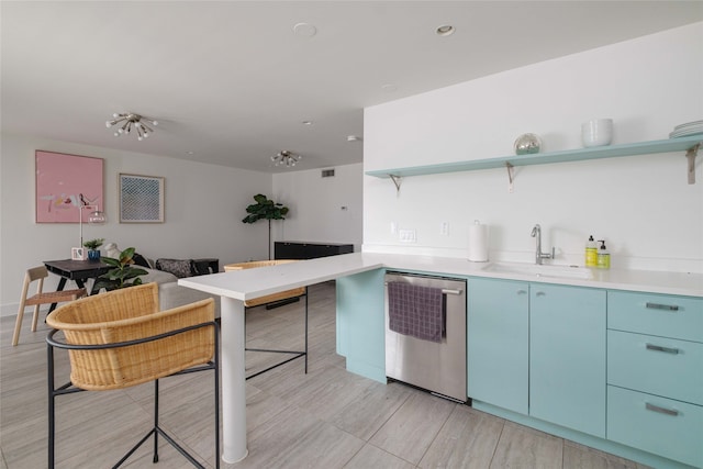 kitchen with blue cabinets, dishwasher, and sink