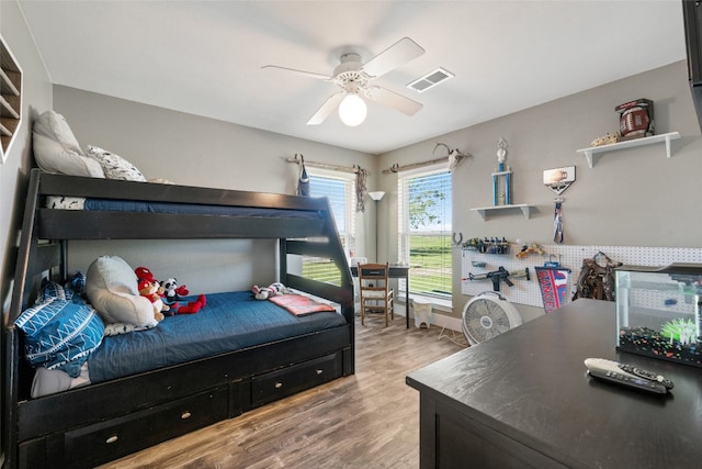 bedroom with ceiling fan and light wood-type flooring