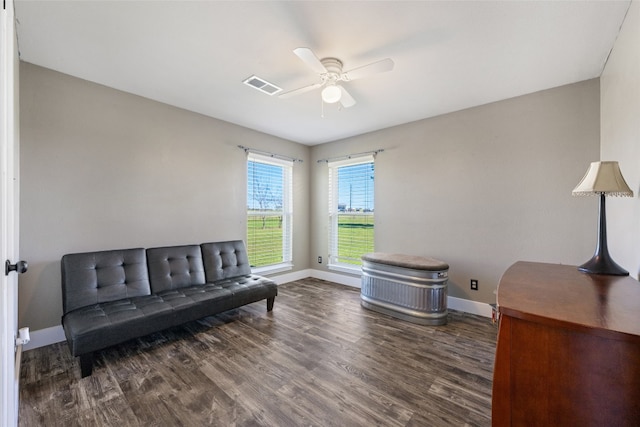 sitting room with dark hardwood / wood-style flooring and ceiling fan