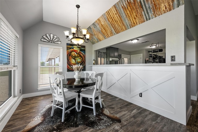 dining space with a notable chandelier, dark wood-type flooring, and vaulted ceiling