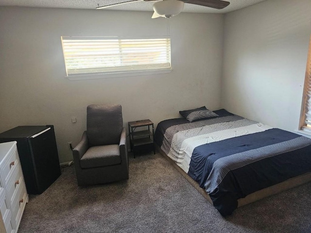 bedroom featuring carpet flooring, a textured ceiling, and ceiling fan