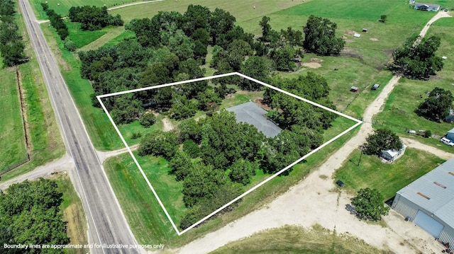 birds eye view of property with a rural view