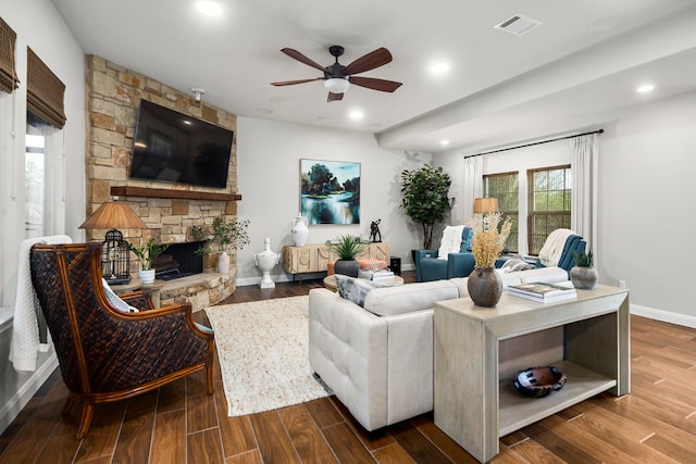 living room with a fireplace, ceiling fan, and hardwood / wood-style floors