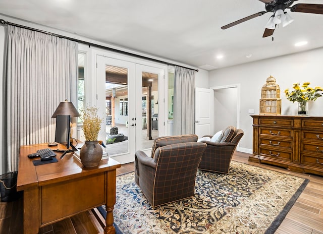 living area featuring french doors, light hardwood / wood-style floors, and ceiling fan