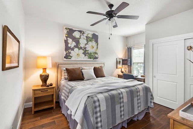 bedroom featuring ceiling fan, dark hardwood / wood-style flooring, and a closet