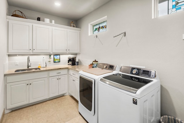 laundry room with cabinets, separate washer and dryer, sink, and a wealth of natural light