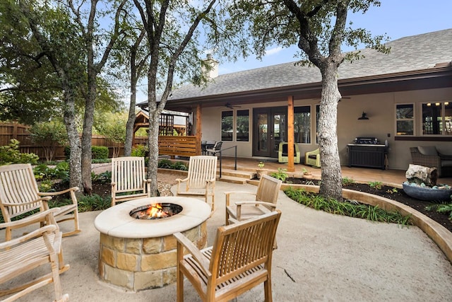 view of patio with ceiling fan and an outdoor fire pit