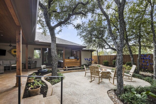 view of patio with an outdoor living space with a fire pit and ceiling fan