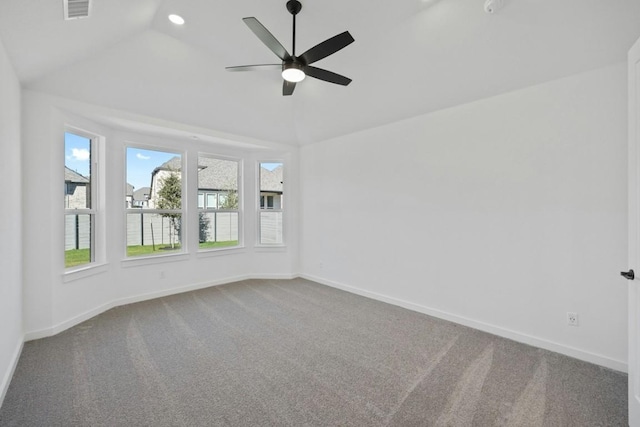 carpeted empty room featuring vaulted ceiling and ceiling fan