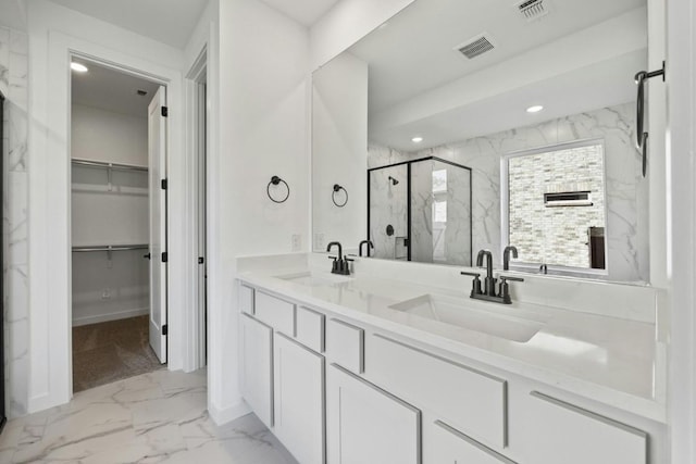 bathroom featuring vanity and a shower with shower door