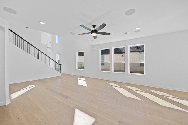 unfurnished living room with ceiling fan and light wood-type flooring