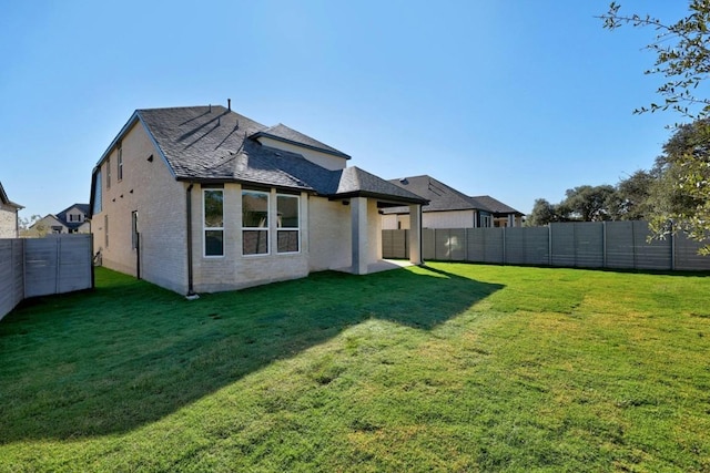 rear view of property featuring a yard