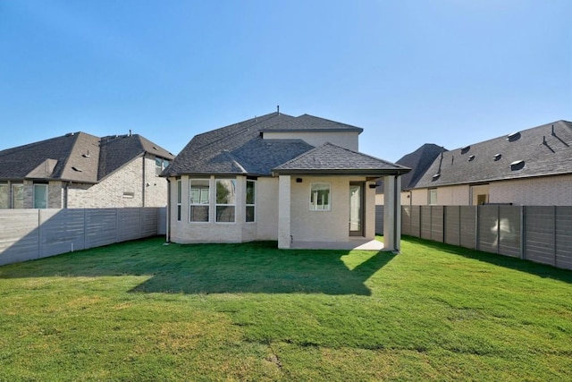 rear view of house featuring a lawn