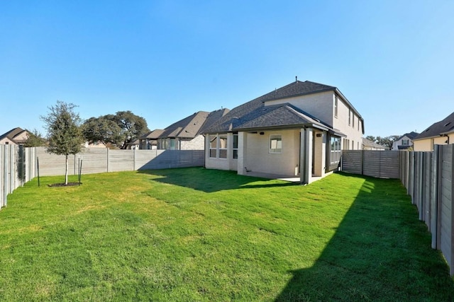 back of property featuring a lawn