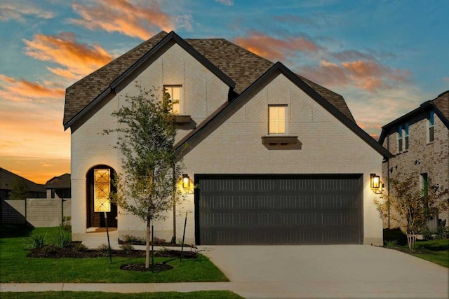 view of front facade featuring a garage and a lawn