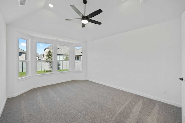 unfurnished room featuring ceiling fan, lofted ceiling, and carpet floors