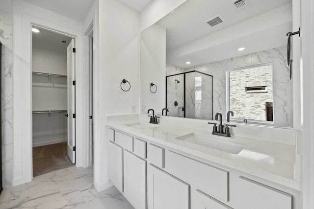 bathroom with a shower with door and vanity