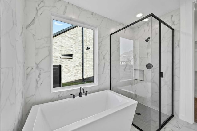 bathroom featuring shower with separate bathtub