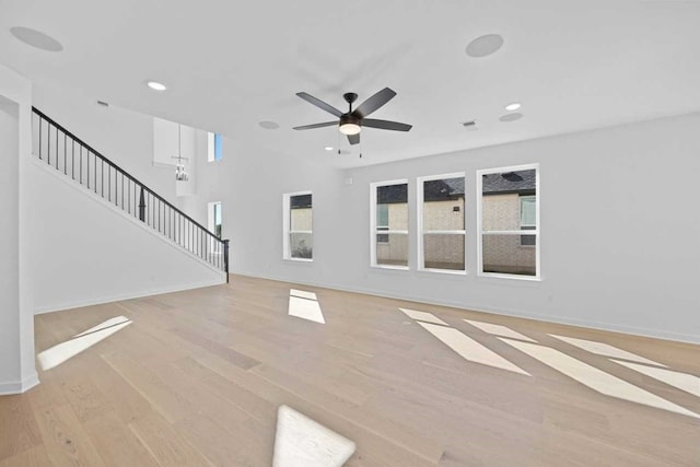 unfurnished living room with ceiling fan and light hardwood / wood-style floors