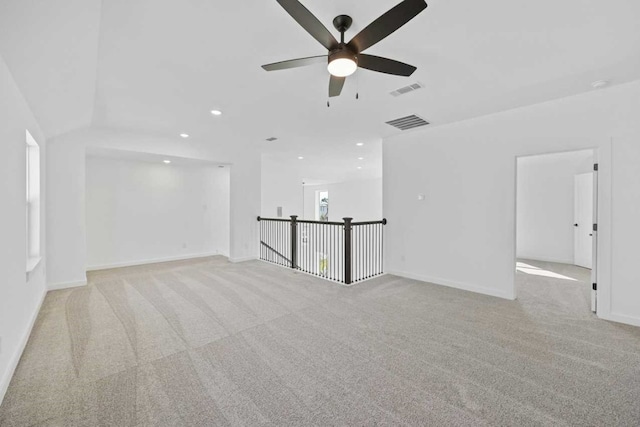 carpeted empty room featuring ceiling fan