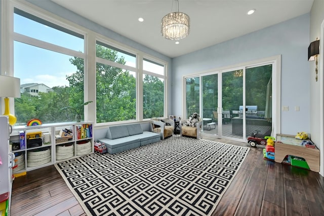 sunroom / solarium with an inviting chandelier