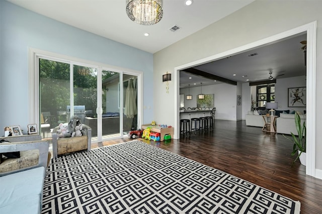 game room with ceiling fan with notable chandelier and wood-type flooring