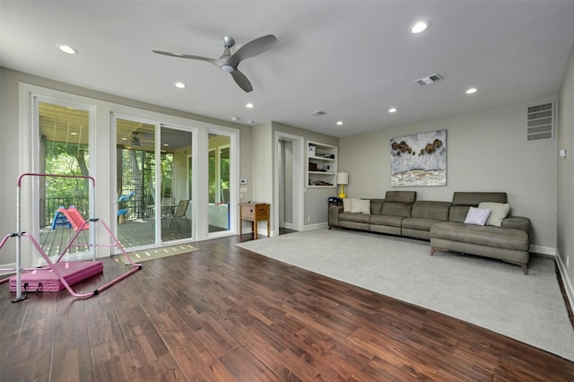 living room featuring ceiling fan and wood-type flooring