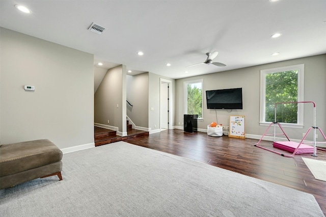 interior space with dark wood-type flooring and ceiling fan