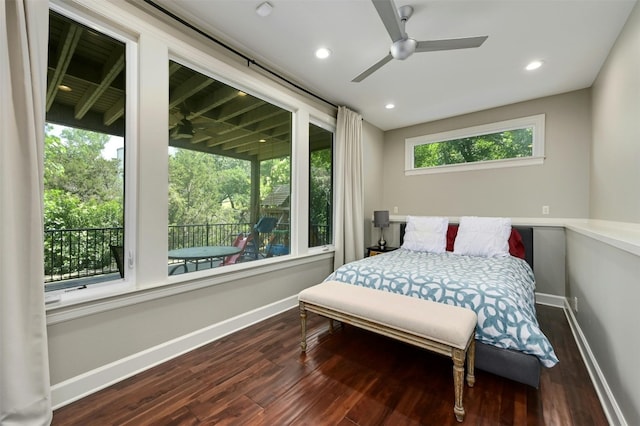 bedroom with hardwood / wood-style floors, ceiling fan, and multiple windows