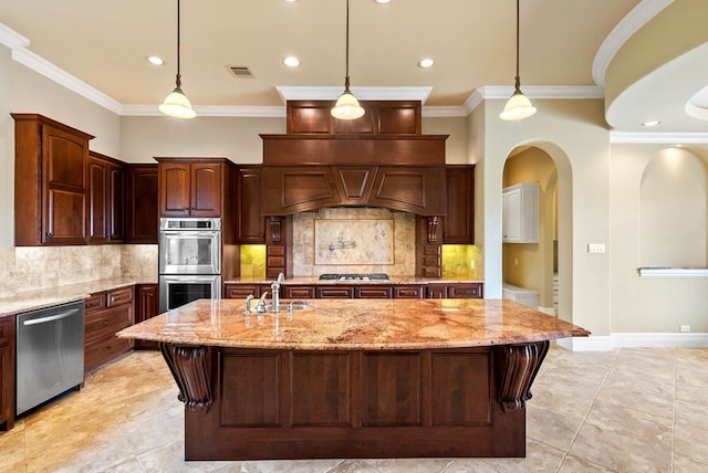 kitchen featuring tasteful backsplash, sink, an island with sink, and stainless steel appliances