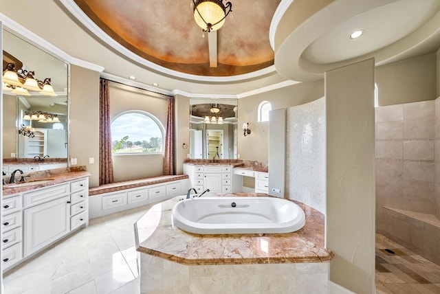 bathroom with a tray ceiling, vanity, shower with separate bathtub, crown molding, and tile patterned floors