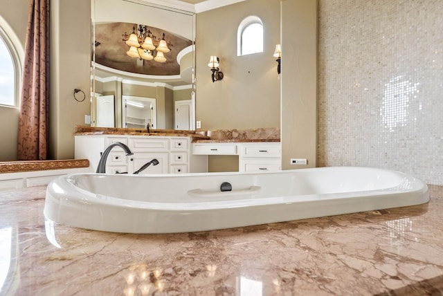 bathroom featuring a tub, vanity, and crown molding