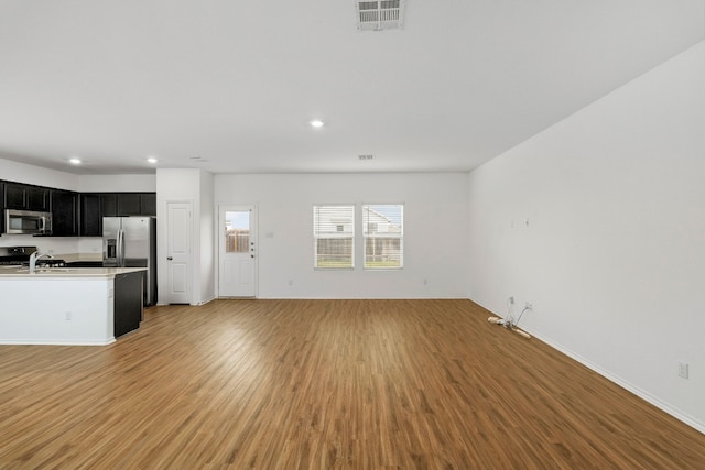 unfurnished living room with light wood-type flooring