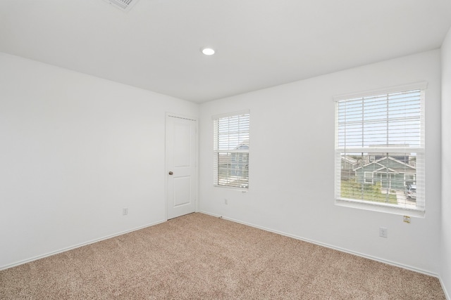 carpeted empty room with plenty of natural light