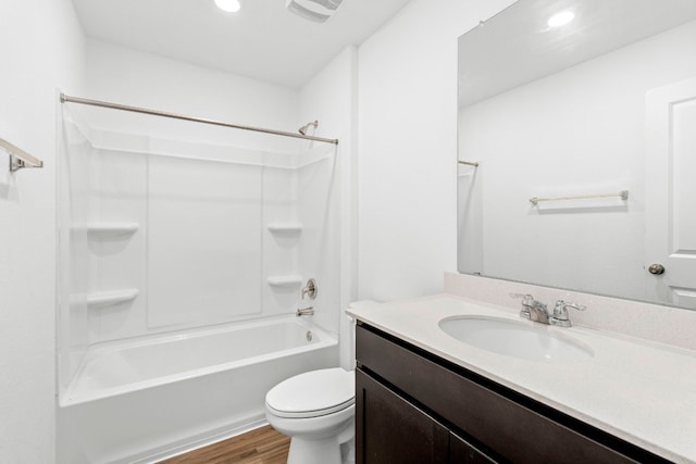 full bathroom featuring toilet, vanity, wood-type flooring, and shower / washtub combination