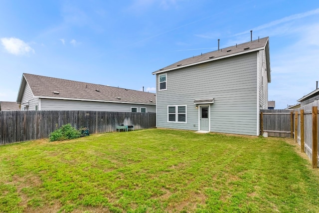 back of house featuring a yard