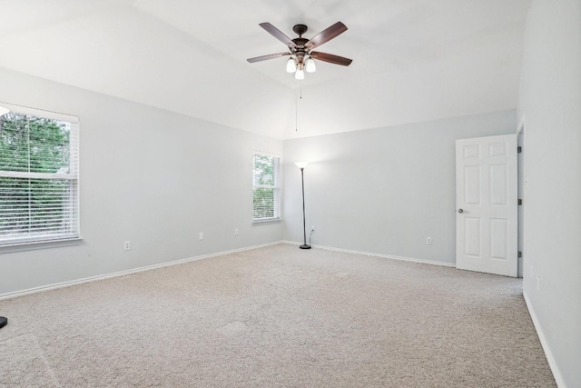 unfurnished room with lofted ceiling and carpet floors